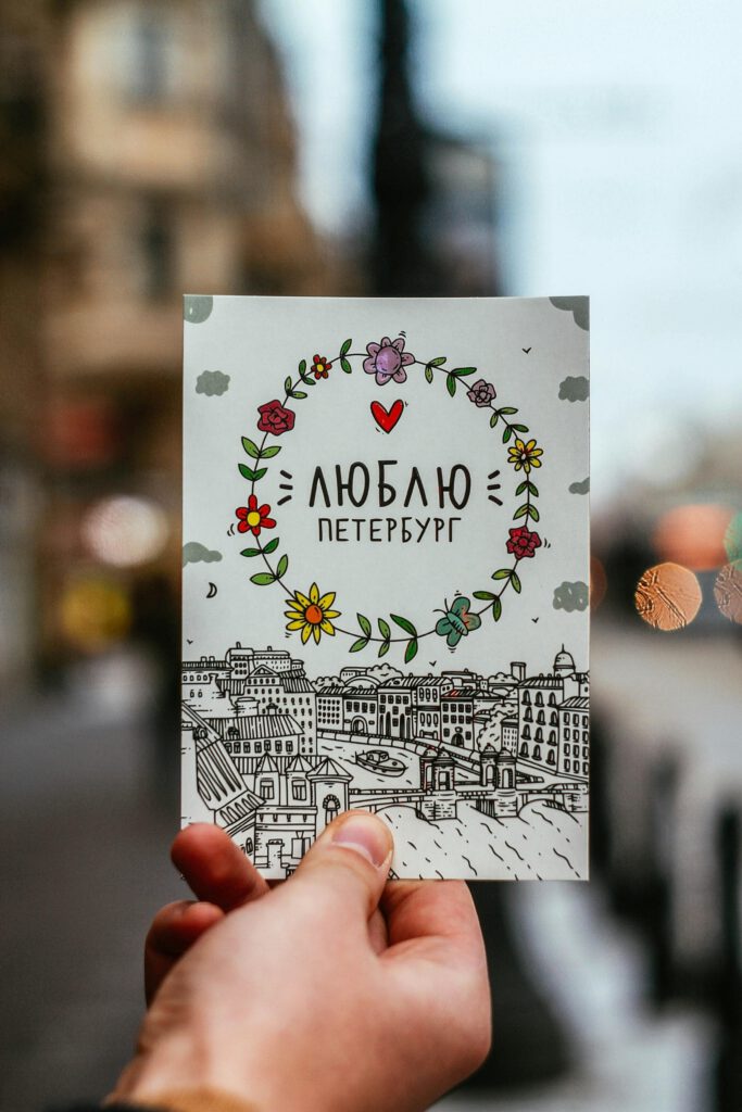 pexels-photo-7790877-7790877 Crop person showing postcard on street